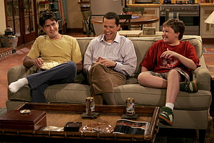 three Person sitting on brown couch