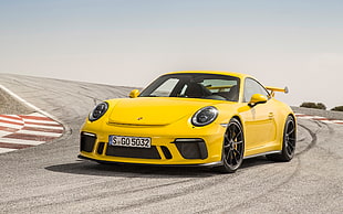 yellow Porsche 911 on road at daytime HD wallpaper