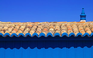 beige shingles on blue containerized housing unit