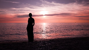 silhouette of woman in shirt watching seashore during golden hour, paola, italy HD wallpaper