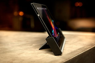 black tablet computer in black stand