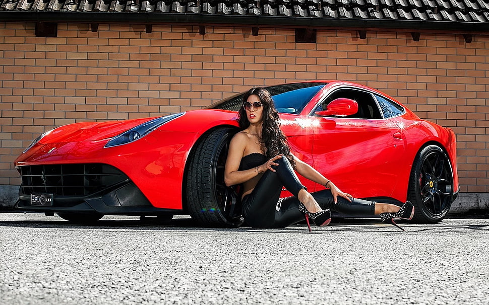 woman wearing black top sitting beside red coupe HD wallpaper