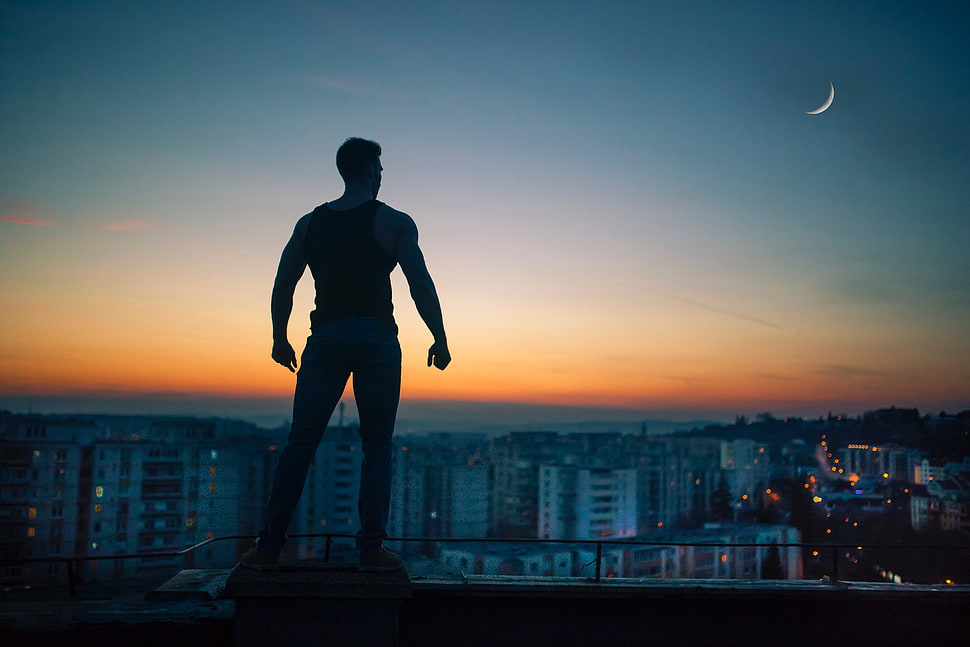 silhouette of man standing on buildings digital wallpaper HD wallpaper