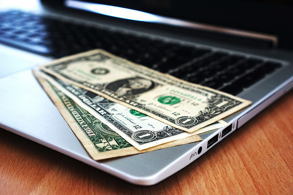 several US dollar bills on gray laptop HD wallpaper