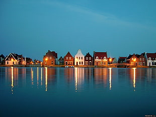 white and brown brick houses, lake, village