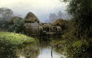 photo of a brown watermill surrounded by trees