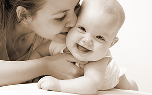 woman kissing baby wearing white top sepia photo HD wallpaper
