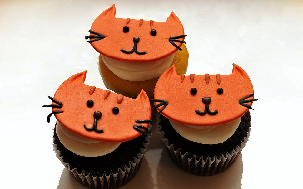 three baked chocolate cupcakes with cat shape decor on top HD wallpaper
