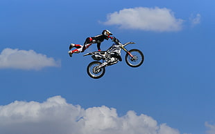 photo of person holding motocross dirt bike in the sky HD wallpaper