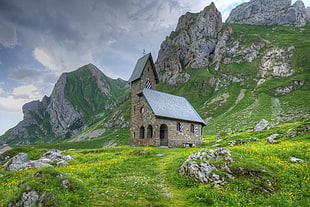 photo of house on mountain surrounded with rocks