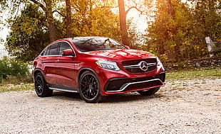 photo of red Mercedes-Benz sedan parked in road HD wallpaper