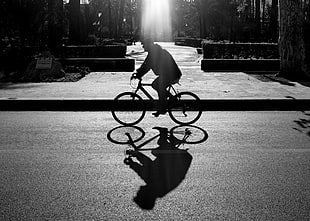man riding on bicycle during daytime in grayscale photo HD wallpaper