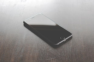 space gray iPhone 6 on top of a table HD wallpaper