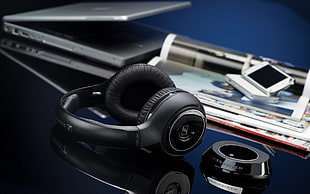 black Sennheiser wireless headphones beside black changing station