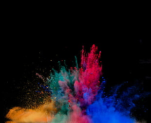 photo of red, blue, green, and yellow holy powders emerged in black background