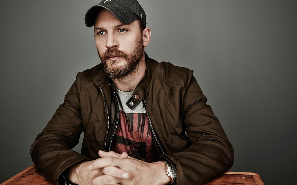 man in brown zip-up jacket and black cap HD wallpaper