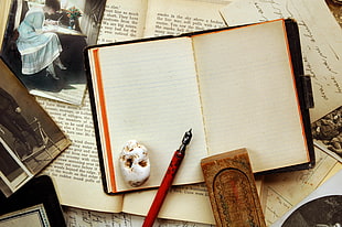 red fountain pen on white book