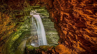 waterfalls between rock formation, nature, rock, cave, waterfall HD wallpaper