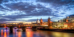 timelapse photography of cityscape with lighted high rise buildings, pauls, thames
