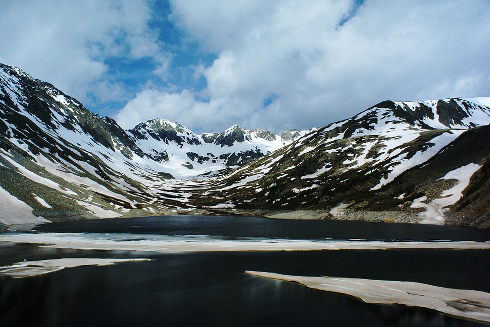 photograph of snow-covered mountain near lake at daytime HD wallpaper