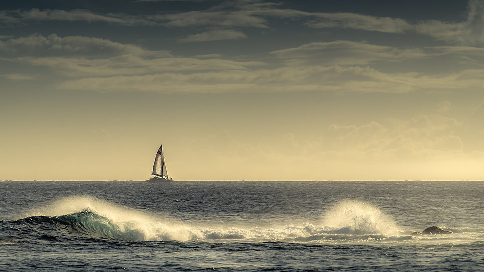 waves on ocean with sailboat at distance HD wallpaper