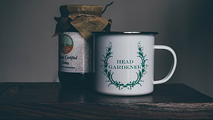 photo of green and white Head Gardener print mug and jar on brown wooden table top