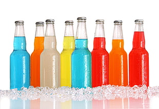 eight glass bottles with ice