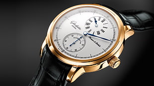 gold-colored and white chronograph watch at 6:10