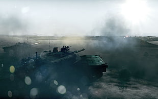photo of two black army tanks firing