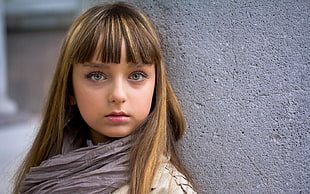 selective focus photography of girl in gray scarf