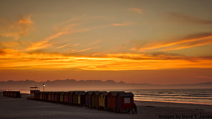 pile of containers beside the sea during golden hour HD wallpaper