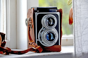 classic camera near glass window