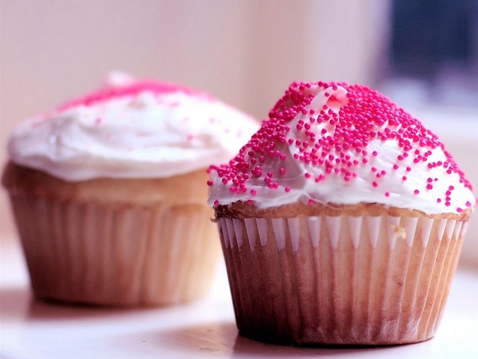 two white cupcakes with pink sprinkles on top HD wallpaper