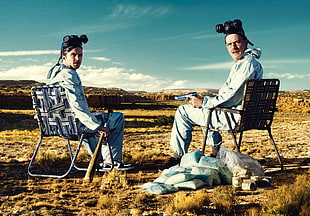 two man sitting on lawn chair in desert during daytime HD wallpaper
