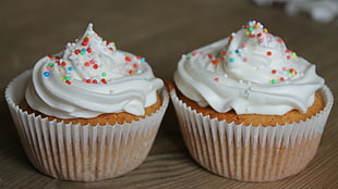 two brown cupcakes with white icings and sprinkles, cupcakes, food