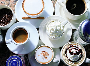 white ceramic mug filled with icing on white ceramic saucer