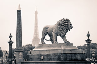 lion sculpture over eiffel tower under cloudy sky at daytime HD wallpaper