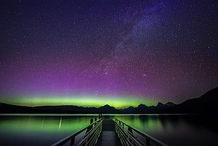 empty dock surrounded with calm body of water under purple and black sky, lake mcdonald, montana HD wallpaper