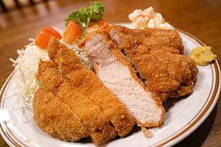cooked meat on round white ceramic plate