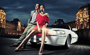 man and woman sitting on convertible car