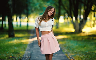 woman wearing white scoop-neck crop top with pink mini skirt