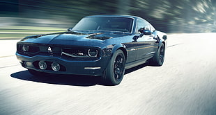 time lapse photography of black Ford Mustang on road