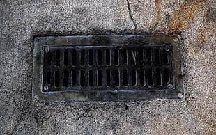 grey metal drainage cover close up photo