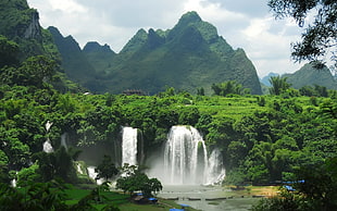 waterfalls surrounded mountains