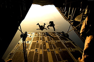 two man jump on plane deck close-up photography