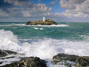 white lighthouse in the middle of the sea HD wallpaper