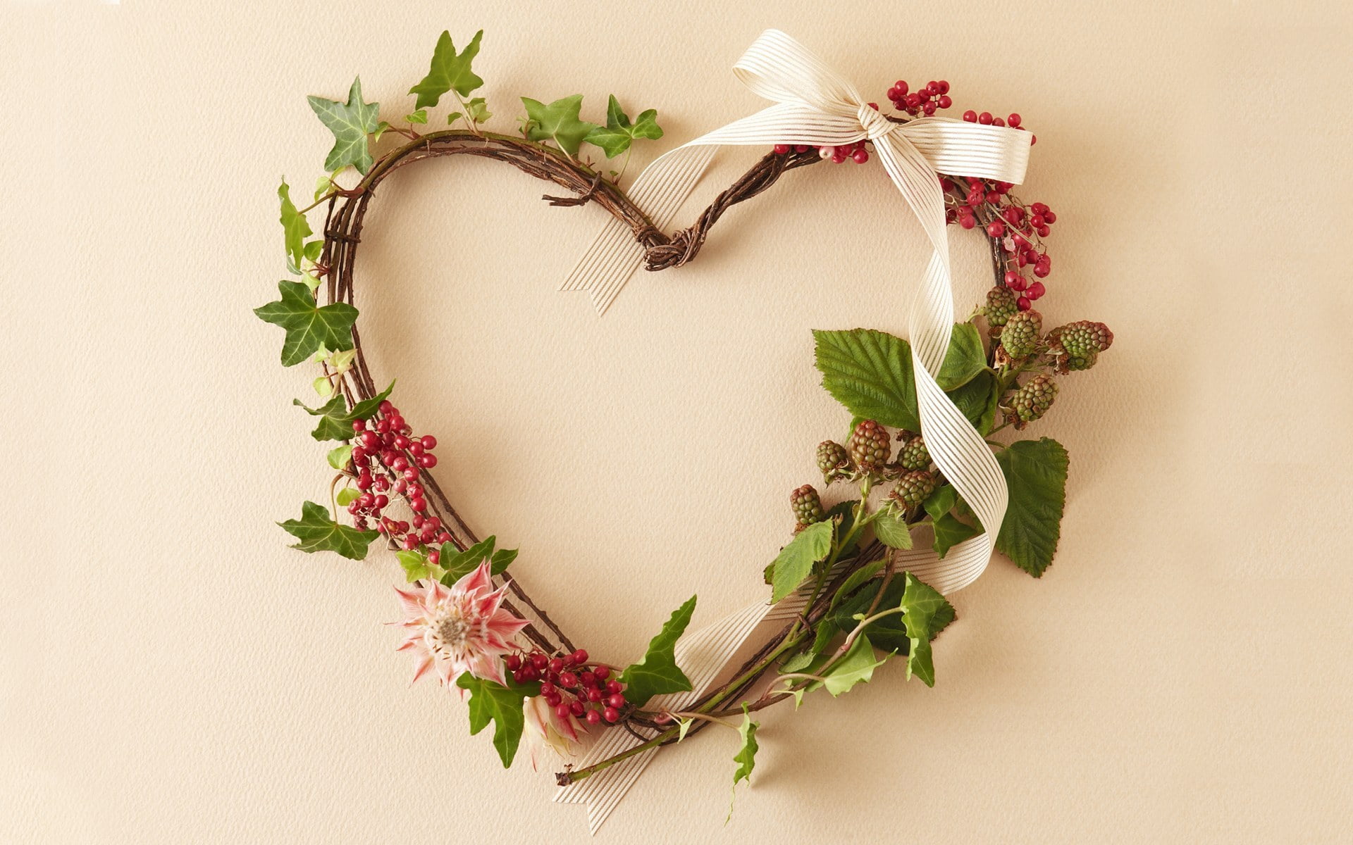 green and white floral heart-shaped wreath hanged on wall
