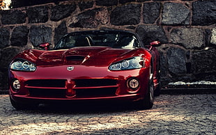 red sports car in front of concrete wall photo HD wallpaper