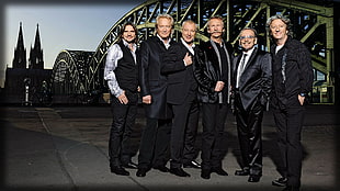 six men wearing suit jackets and smiling