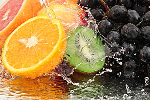 assorted colored fruits with water